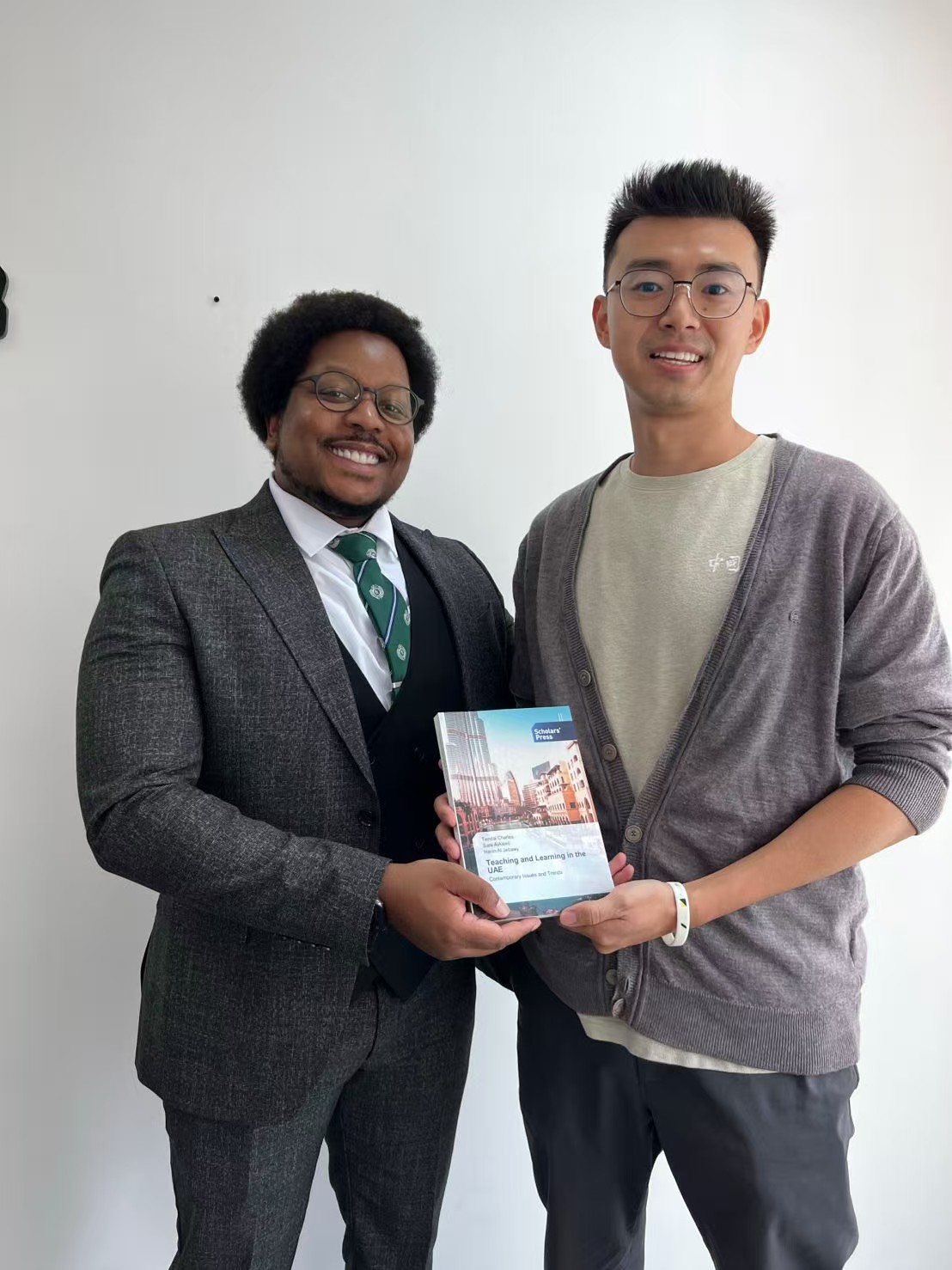 Dr. Shan Jin with his doctoral supervisor, Dr Tendai Charles, holding a published book